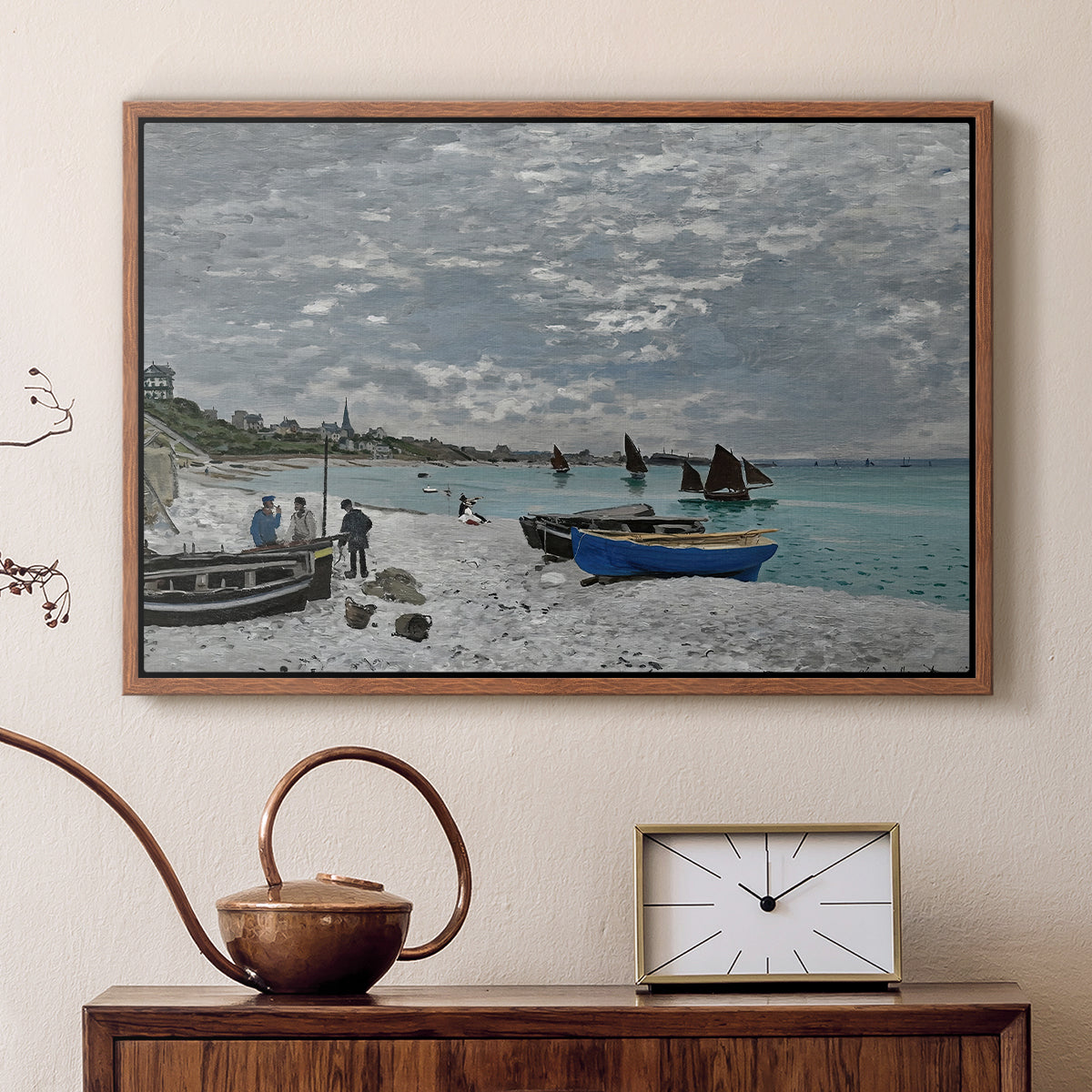 Walnut floater framed canvas featuring a coastal landscape with sailboats and visitors on cliffside, displayed above a cabinet in a soft-toned living room.