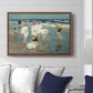 A Holiday, c. 1915 by Edward Henry Potthast displayed above a sofa in a living room in a walnut floater frame, featuring a beach scene with figures bathing and standing in waves under bright sky.