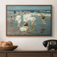 A Holiday, c. 1915 by Edward Henry Potthast in a walnut floater framed canvas displayed above a console table in a hallway, featuring a lively shoreline scene with people gathered in surf.