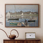 Walnut floater framed canvas featuring a harbor basin filled with boats under soft sky, displayed above a cabinet in a soft-toned living room.