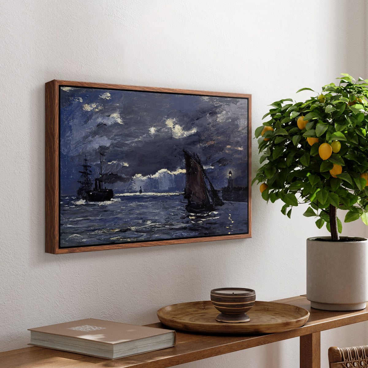 A Seascape, Shipping by Moonlight, 1864 by Claude Monet, presented in a walnut floater framed canvas featuring ships on dark sea illuminated by moonlight under night sky, displayed above a hallway console table.