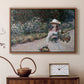 Walnut floater framed canvas featuring a figure resting in colorful garden under soft light, displayed above a cabinet in a soft-toned living room.