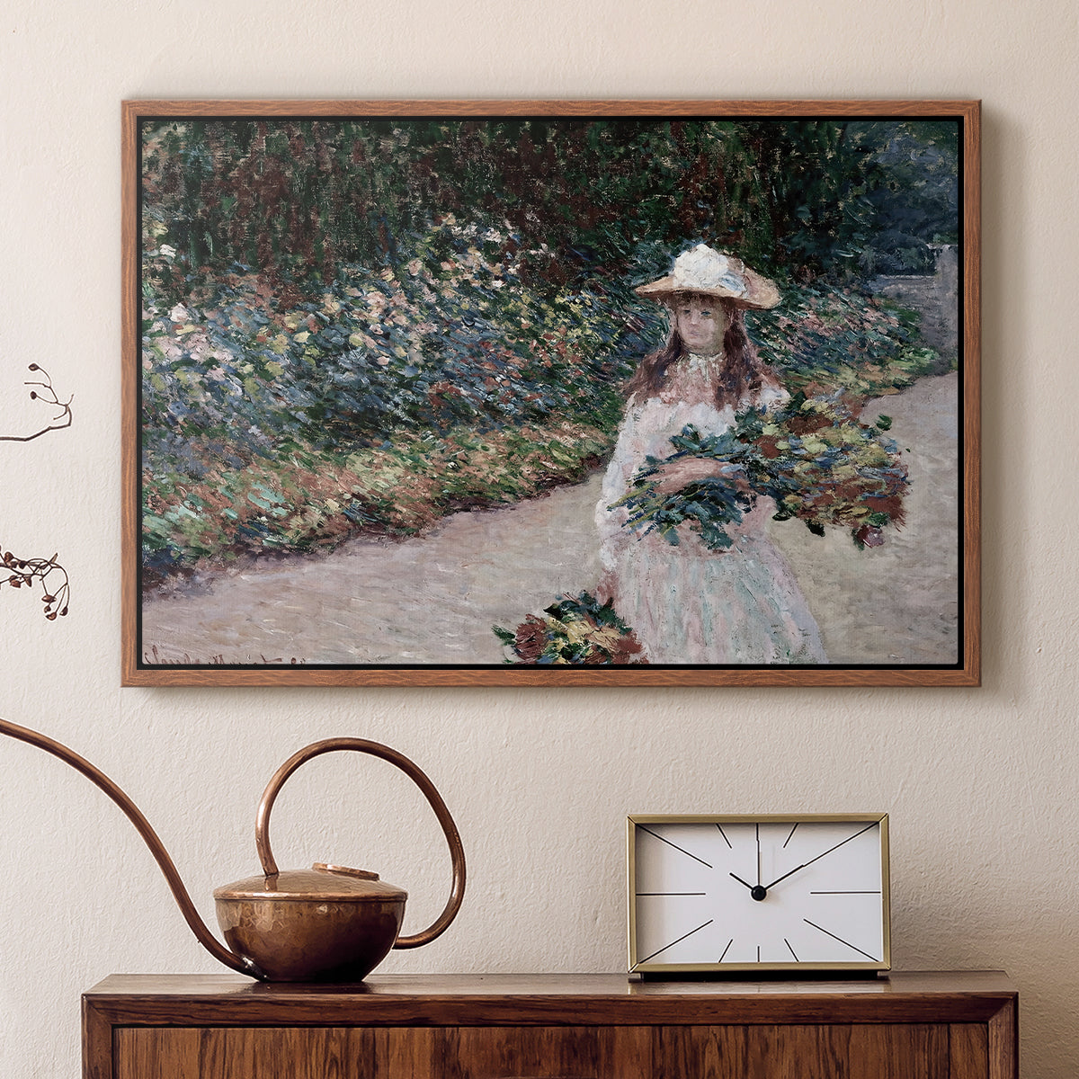 Walnut floater framed canvas featuring a figure resting in colorful garden under soft light, displayed above a cabinet in a soft-toned living room.