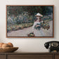 Young Girl in the Garden at Giverny, 1888 by Claude Monet in a walnut floater framed canvas displayed above a console table in a hallway, featuring a tranquil outdoor portrait of girl in floral setting.