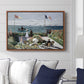 Garden at Sainte-Adresse, 1867 by Claude Monet displayed above a sofa in a living room in a walnut floater frame, featuring an impressionist coastal garden with people and ocean view.