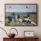 Walnut floater framed canvas featuring a vibrant garden scene with colorful blooms and distant sea, displayed above a cabinet in a soft-toned living room.