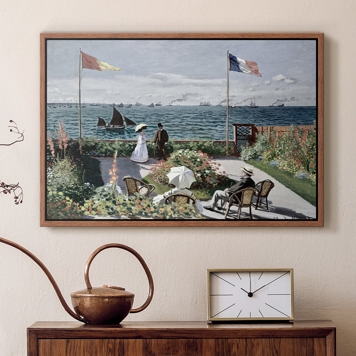 Walnut floater framed canvas featuring a vibrant garden scene with colorful blooms and distant sea, displayed above a cabinet in a soft-toned living room.