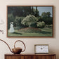 Walnut floater framed canvas featuring an elegant woman posed outdoors among blooming plants, displayed above a cabinet in a soft-toned living room.