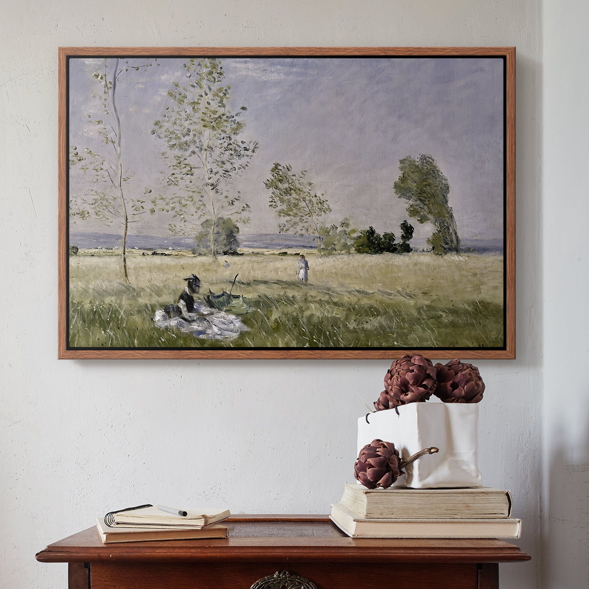 Walnut floater framed canvas featuring Summer (L'ete), 1874 by Claude Monet above an entryway table in a minimalist foyer.