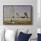 Summer (L'ete), 1874 by Claude Monet displayed above a sofa in a living room in a walnut floater frame, featuring an impressionist countryside scene with figure resting in shade.