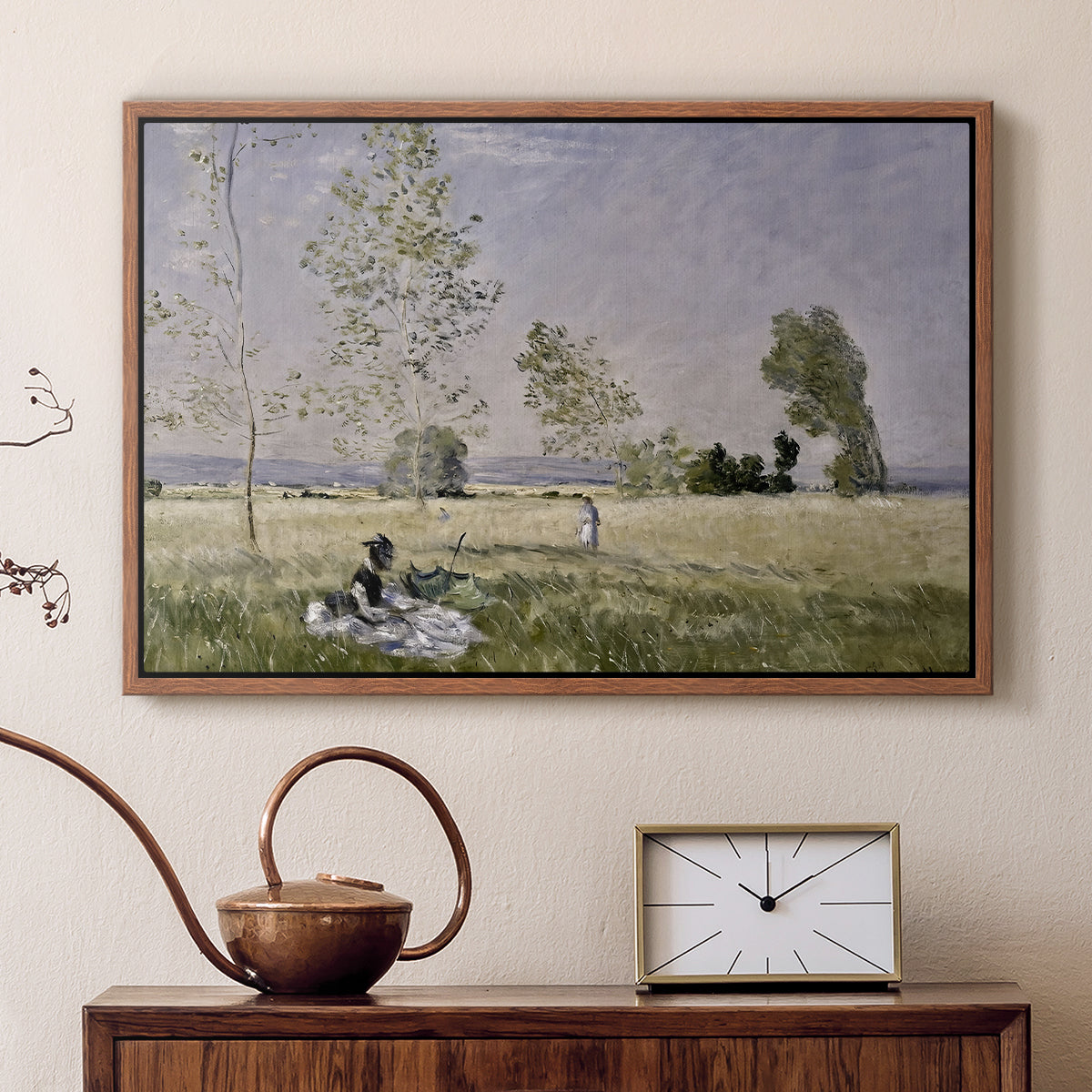 Walnut floater framed canvas featuring a sunlit meadow with woman surrounded by greenery, displayed above a cabinet in a soft-toned living room.