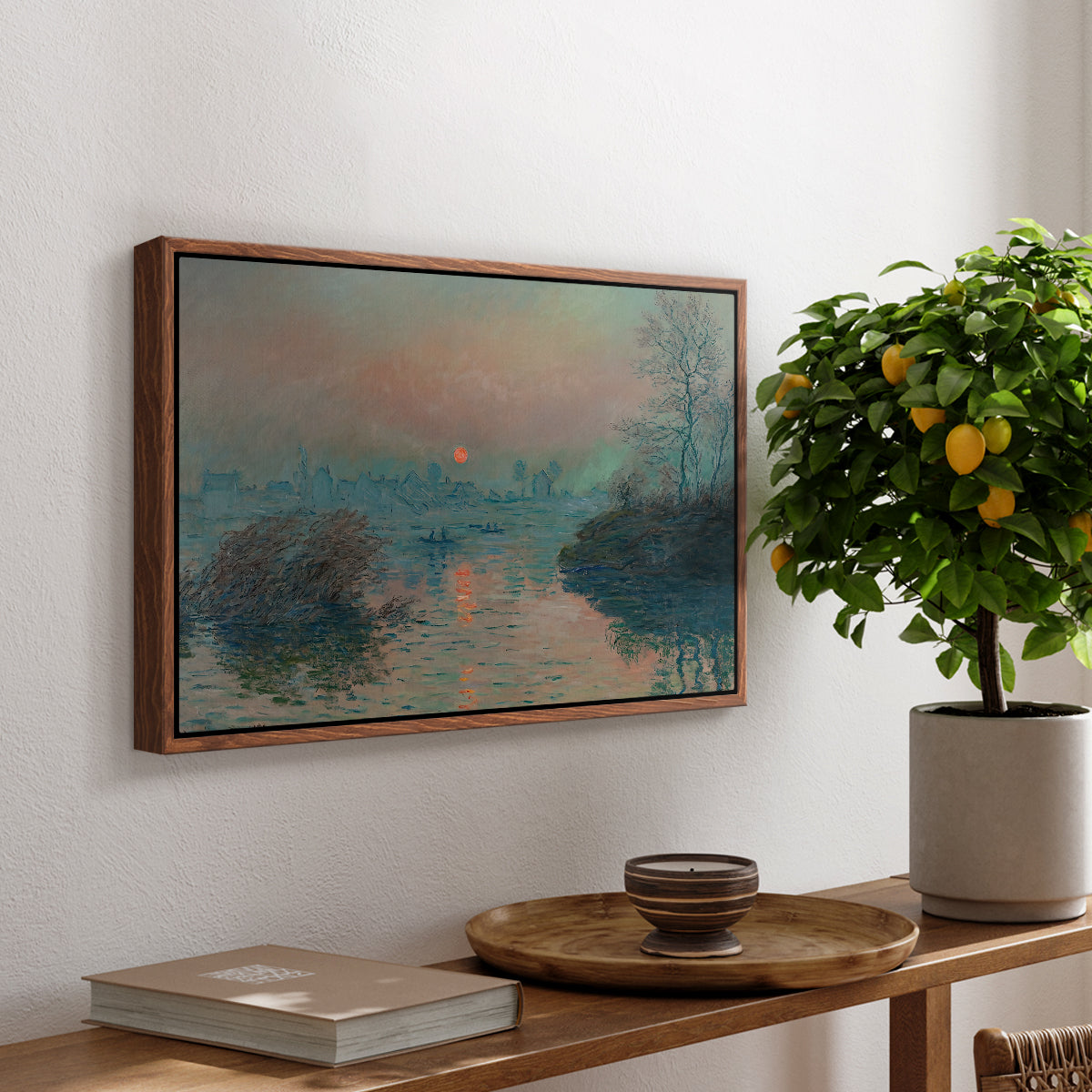 Sunset on the Seine at Lavacourt, Winter Effect, 1880 by Claude Monet, presented in a walnut floater framed canvas featuring a glowing sunset over snowy river landscape with soft reflections, displayed above a hallway console table.
