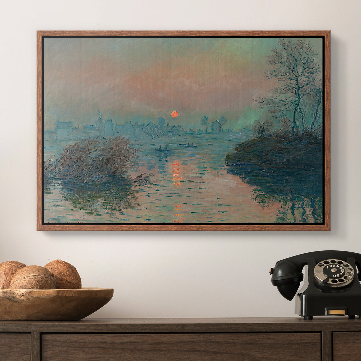 Sunset on the Seine at Lavacourt, Winter Effect, 1880 by Claude Monet in a walnut floater framed canvas displayed above a console table in a hallway, featuring an atmospheric landscape combining cold tones and warm sky.