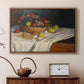 Walnut floater framed canvas featuring a close-up of apples and grapes in warm tones, displayed above a cabinet in a soft-toned living room.