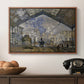 The Gare Saint-Lazare, 1877 by Claude Monet in a walnut floater framed canvas displayed above a console table in a hallway, featuring a bustling transport hub with trains beneath glass roof.