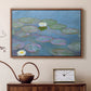 Walnut floater framed canvas featuring a tranquil water surface covered with blooming lilies, displayed above a cabinet in a soft-toned living room.
