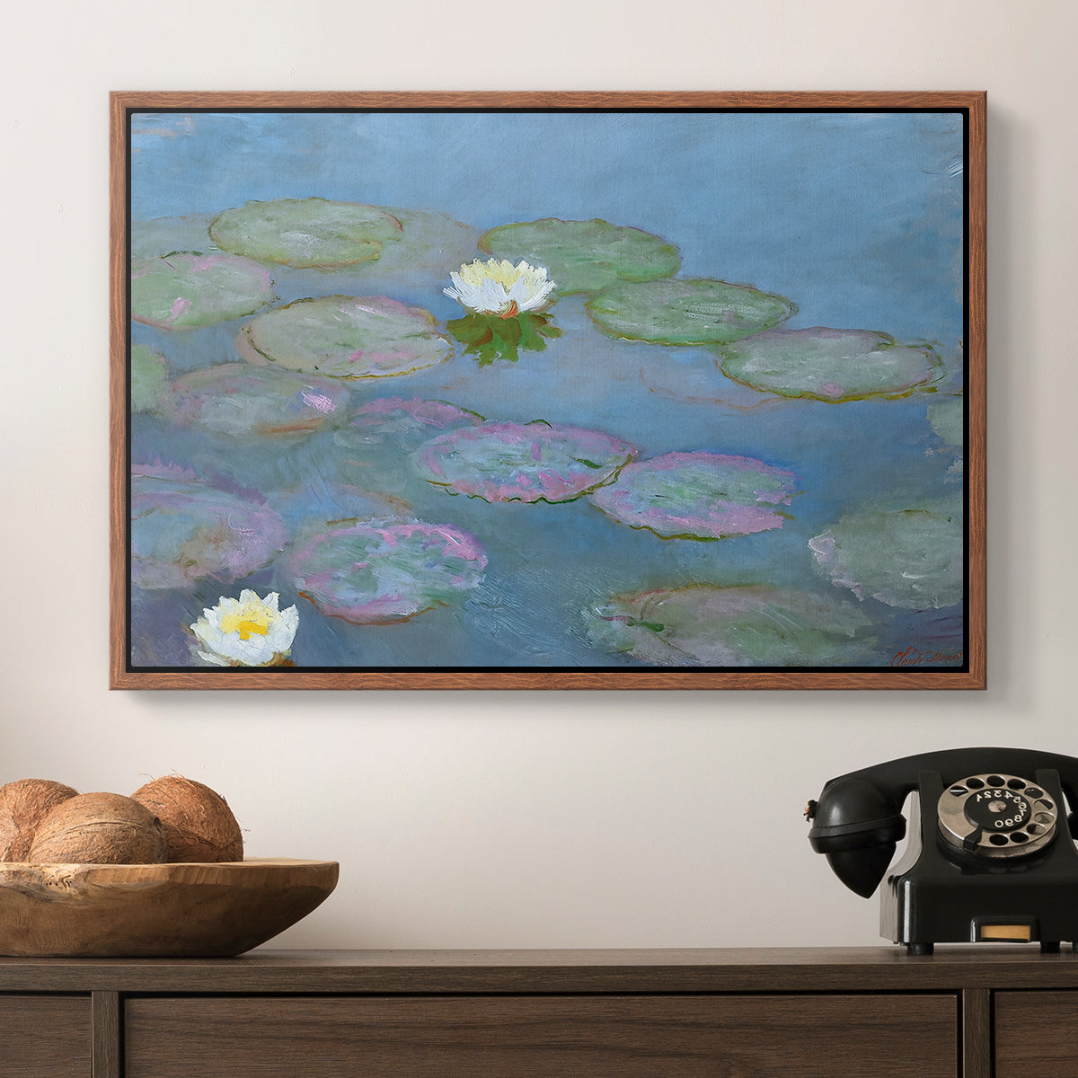 Water Lilies (Nymphéas), 1897-1899 by Claude Monet in a walnut floater framed canvas displayed above a console table in a hallway, featuring a close-up of aquatic plants in still water.