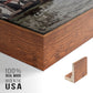 Close-up of the walnut floater frame corner and gallery wrapped canvas construction.
