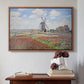 Walnut floater framed canvas featuring Tulip Fields with the Rijnsburg Windmill, 1886 by Claude Monet above an entryway table in a minimalist foyer.