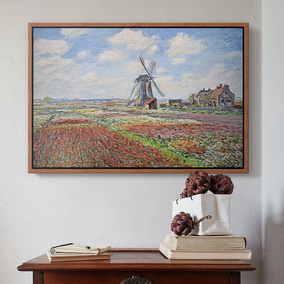Walnut floater framed canvas featuring Tulip Fields with the Rijnsburg Windmill, 1886 by Claude Monet above an entryway table in a minimalist foyer.