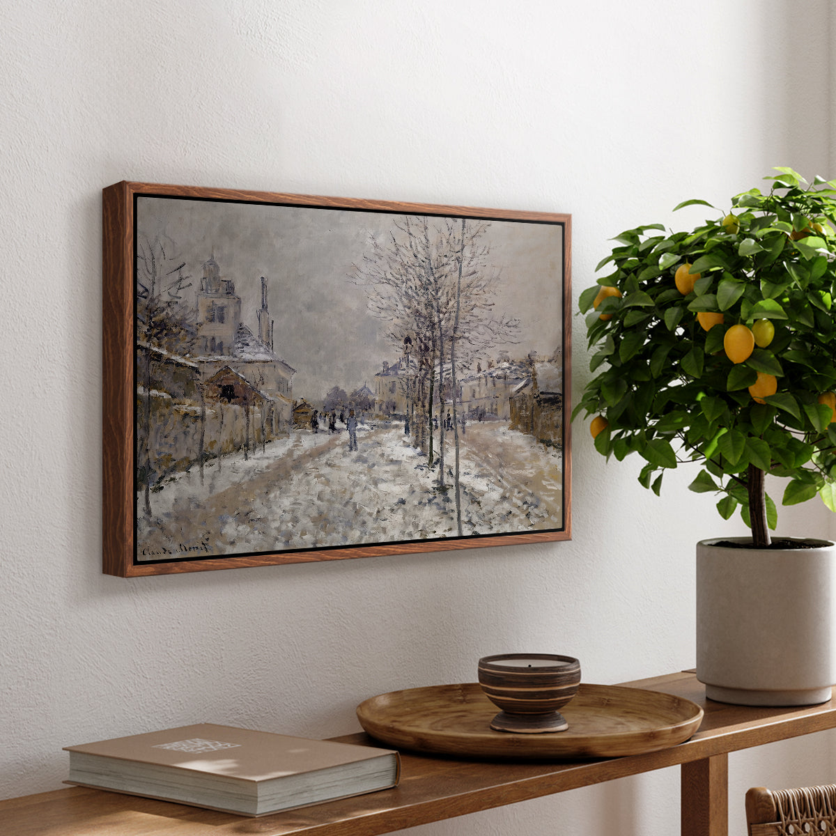 The Boulevard de Pontoise at Argenteuil, Snow Effect, 1875 by Claude Monet, presented in a walnut floater framed canvas featuring a snow-covered street lined with trees and buildings under winter sky, displayed above a hallway console table.