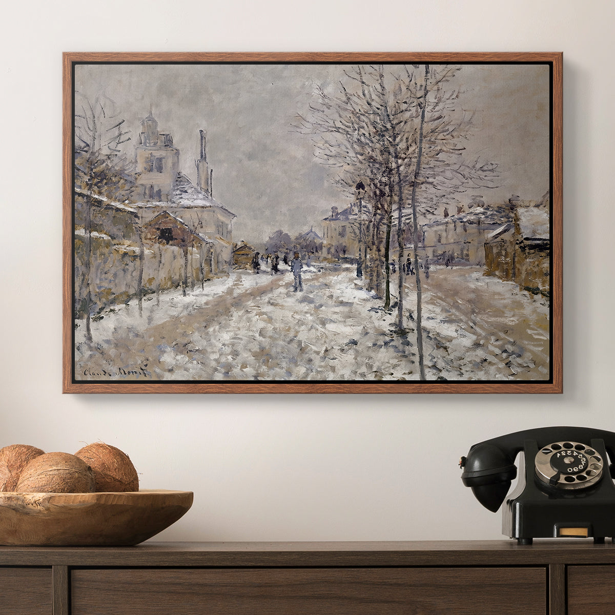 The Boulevard de Pontoise at Argenteuil, Snow Effect, 1875 by Claude Monet in a walnut floater framed canvas displayed above a console table in a hallway, featuring an urban winter landscape with muted tones and soft light.