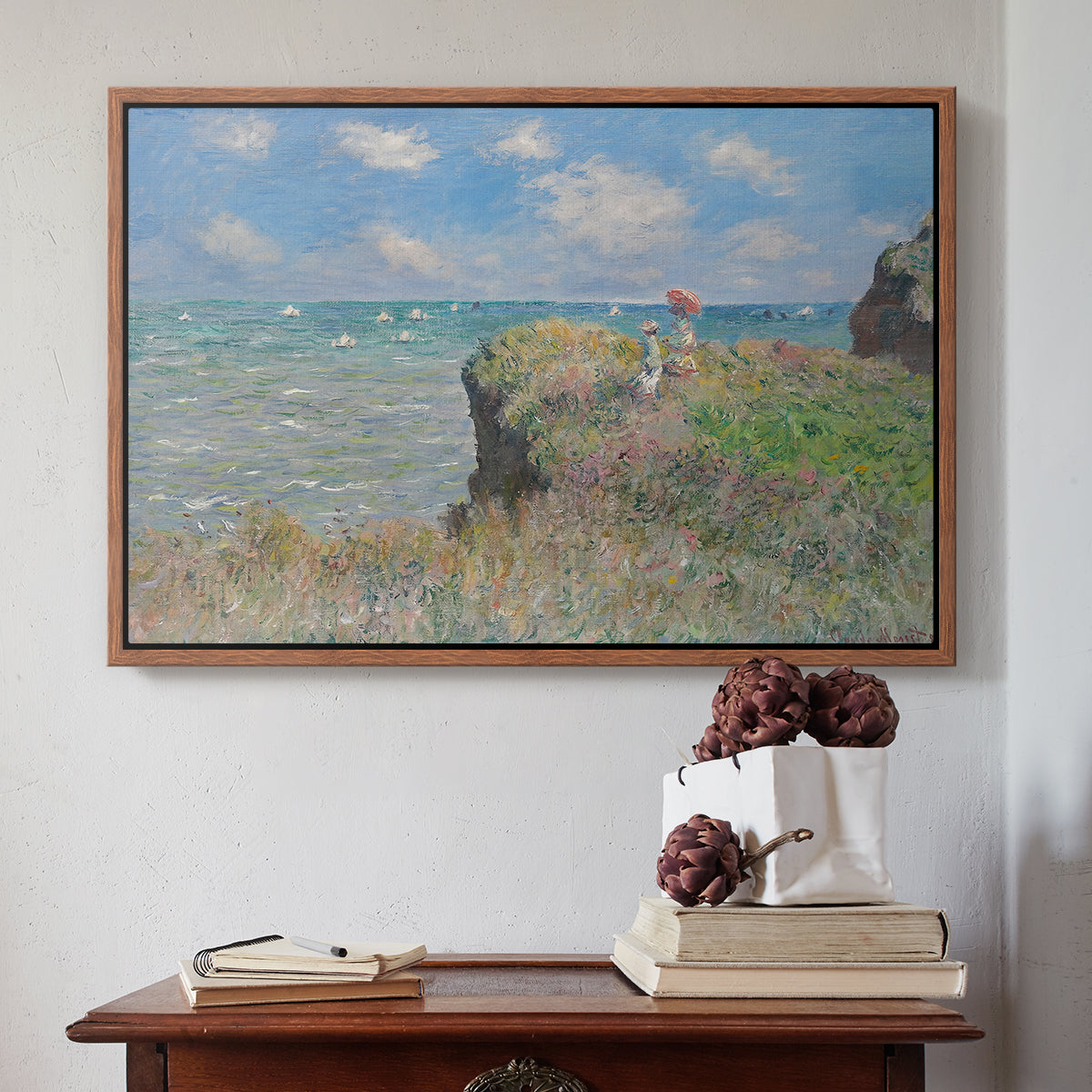 Walnut floater framed canvas featuring The Cliff Walk at Pourville, 1882 by Claude Monet above an entryway table in a minimalist foyer.