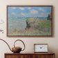 Walnut floater framed canvas featuring a coastal cliff scene with grass, wind, and expansive sea view, displayed above a cabinet in a soft-toned living room.