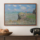 The Cliff Walk at Pourville, 1882 by Claude Monet in a walnut floater framed canvas displayed above a console table in a hallway, featuring an elevated shoreline path with figures and bright sky.