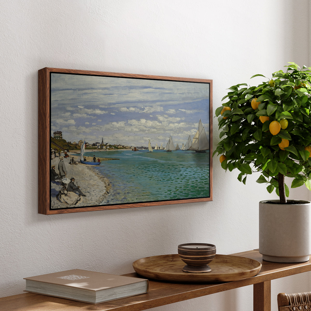 Regatta at Sainte-Adresse, 1867 by Claude Monet, presented in a walnut floater framed canvas featuring sailboats gathered near shore with flags and spectators along coastline, displayed above a hallway console table.