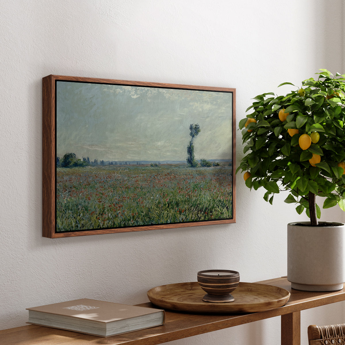Poppy Field, 1881 by Claude Monet, presented in a walnut floater framed canvas featuring a wide field of red poppies stretching across countryside under open sky, displayed above a hallway console table.