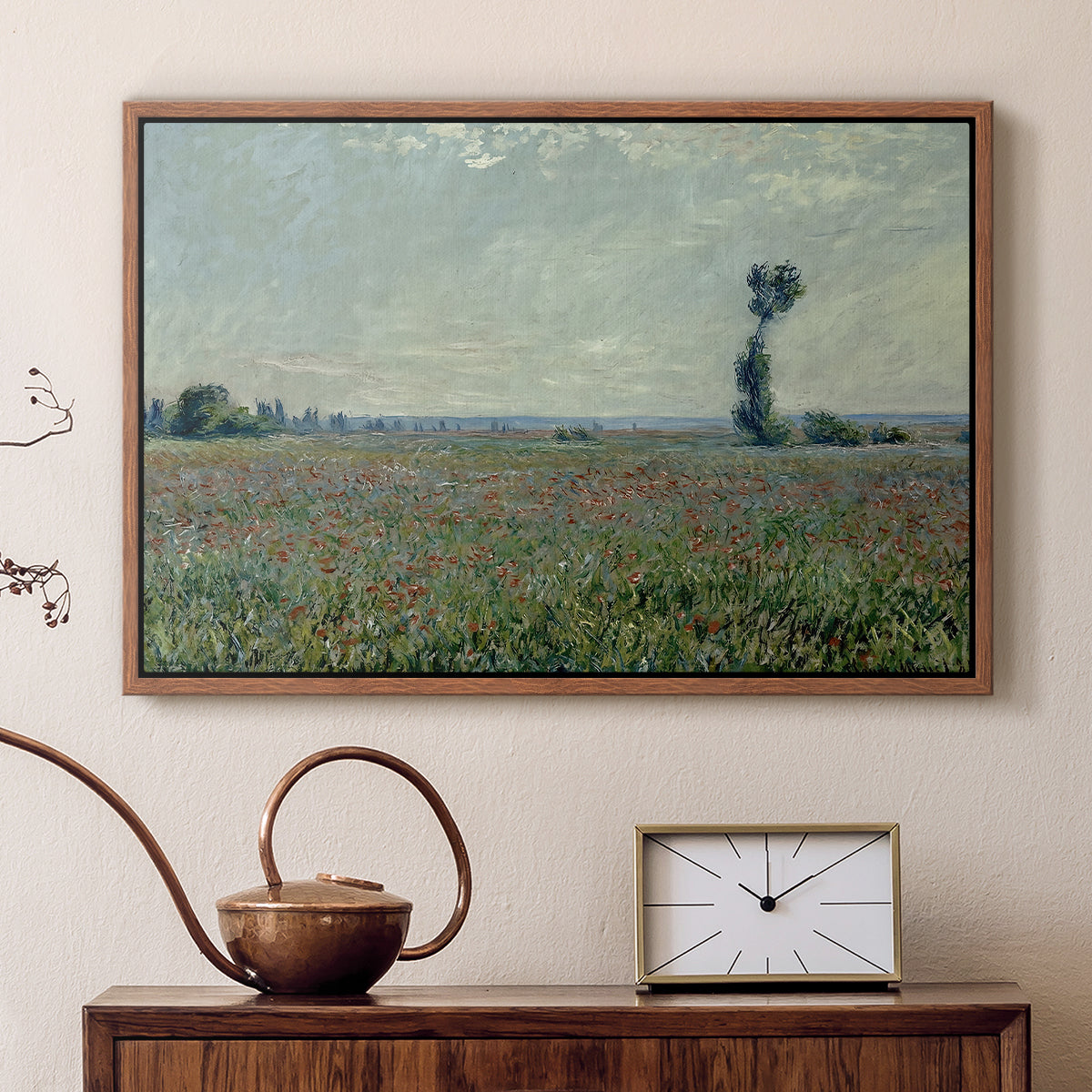 Walnut floater framed canvas featuring a rural meadow with scattered poppies and soft horizon, displayed above a cabinet in a soft-toned living room.