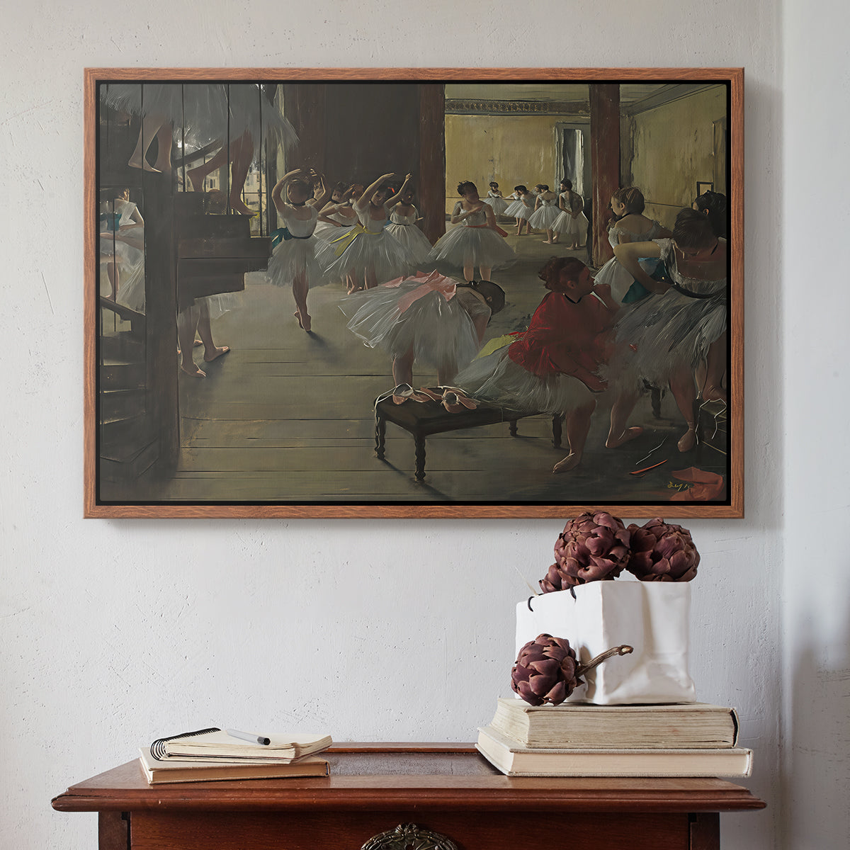Walnut floater framed canvas featuring The Dance Class, c. 1873 by Edgar Degas above an entryway table in a minimalist foyer.