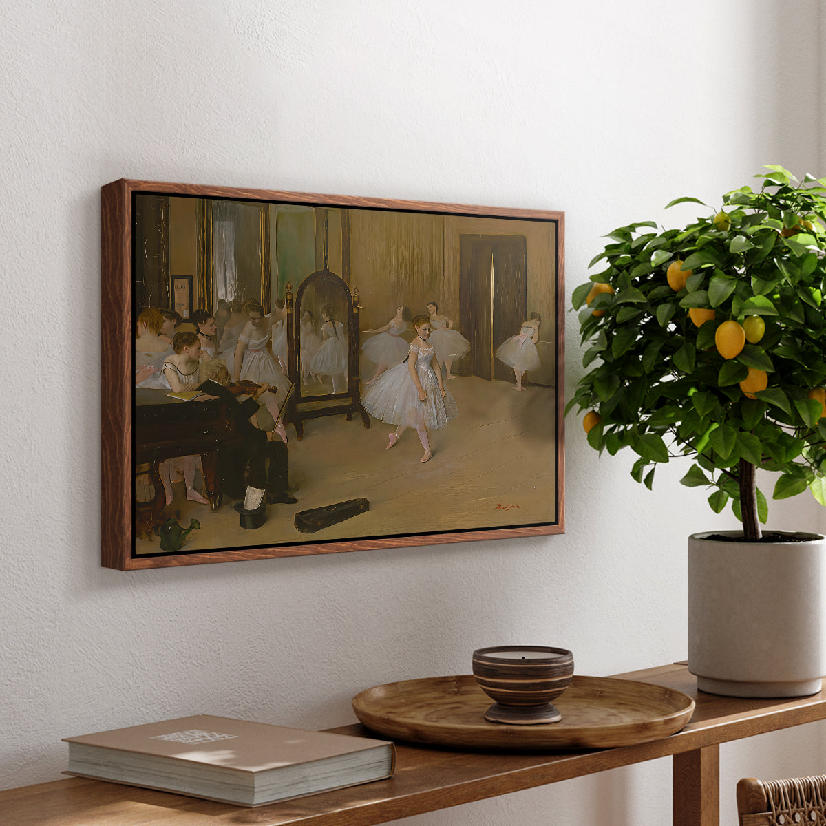 The Dancing Class, c. 1870 by Edgar Degas, presented in a walnut floater framed canvas featuring a ballet class with dancers practicing positions under instructor guidance, displayed above a hallway console table.