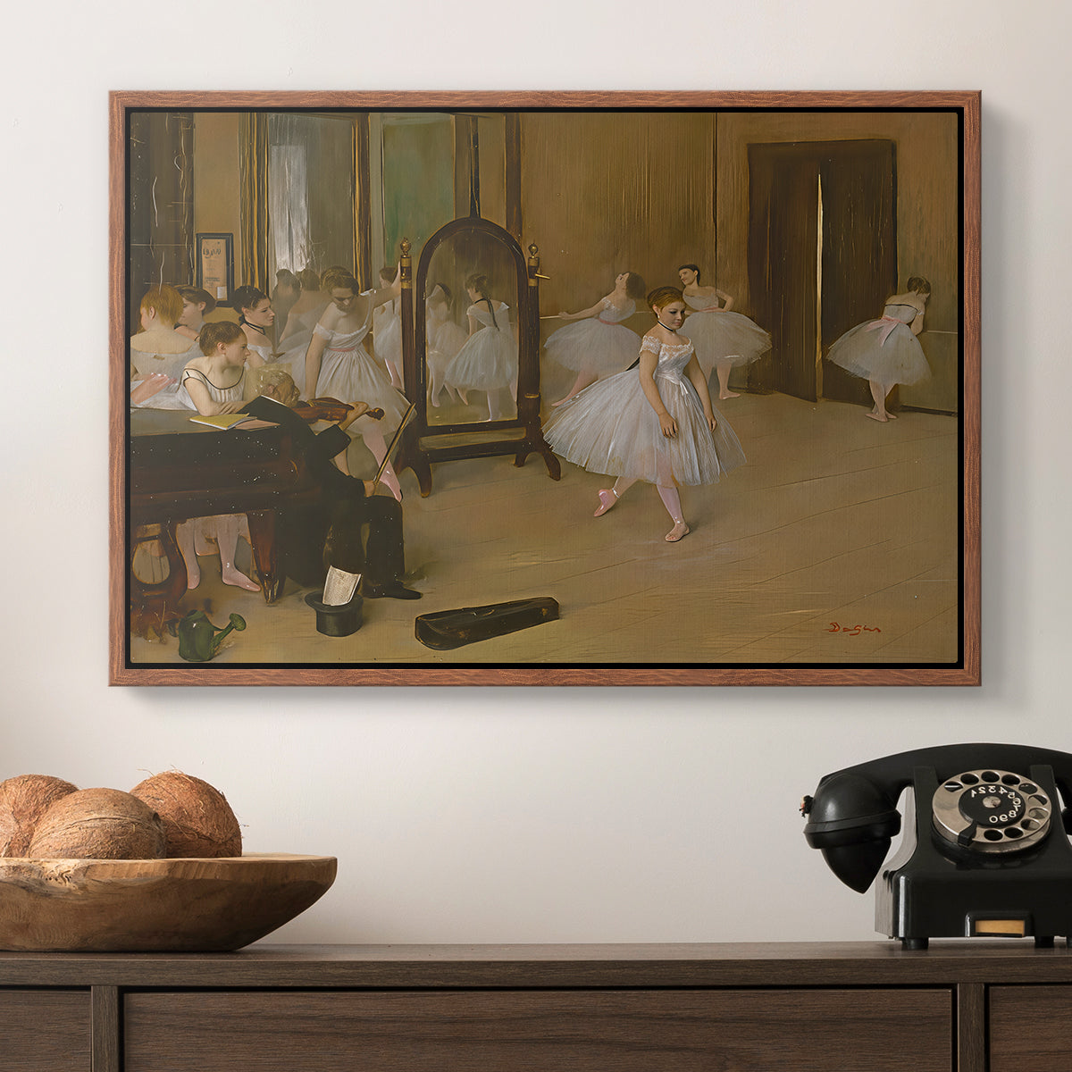 The Dancing Class, c. 1870 by Edgar Degas in a walnut floater framed canvas displayed above a console table in a hallway, featuring a group of dancers mid-practice with teacher overseeing.