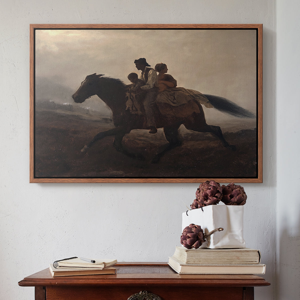 Walnut floater framed canvas featuring A Ride for Liberty – The Fugitive Slaves, c. 1862 by Eastman Johnson above an entryway table in a minimalist foyer.