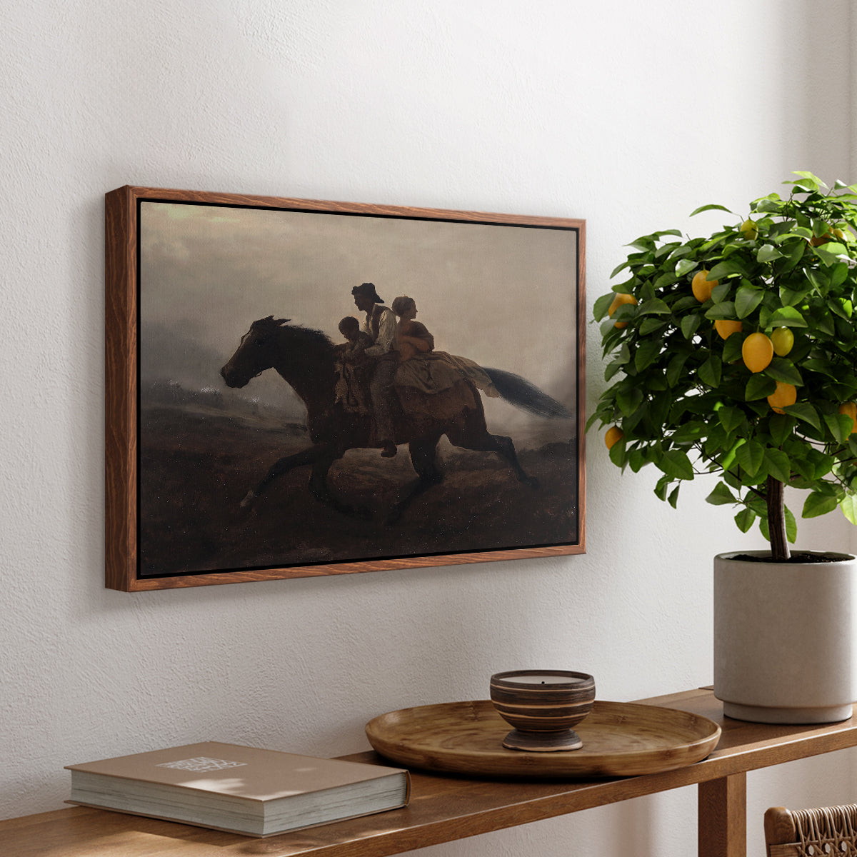 A Ride for Liberty – The Fugitive Slaves, c. 1862 by Eastman Johnson, presented in a walnut floater framed canvas featuring a family riding horseback through night escaping across landscape, displayed above a hallway console table.