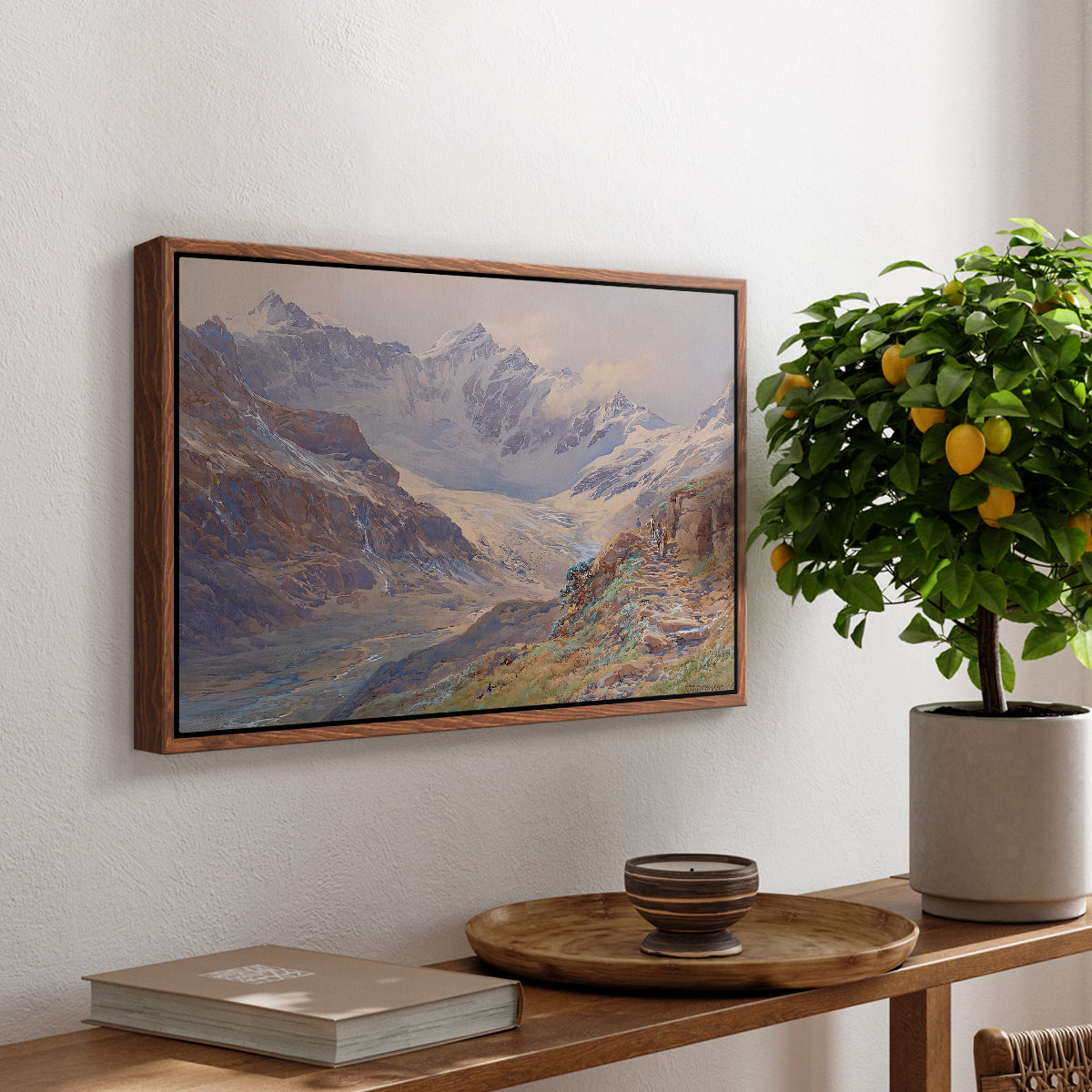 Odenwinklkees with the Johannisberg, 1902 by Edward Theodore Compton, presented in a walnut floater framed canvas featuring an alpine glacier landscape with rugged peaks and snow-covered terrain, displayed above a hallway console table.