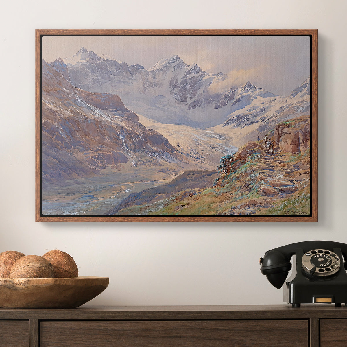 Odenwinklkees with the Johannisberg, 1902 by Edward Theodore Compton in a walnut floater framed canvas displayed above a console table in a hallway, featuring an expansive alpine view with ice and distant mountains.