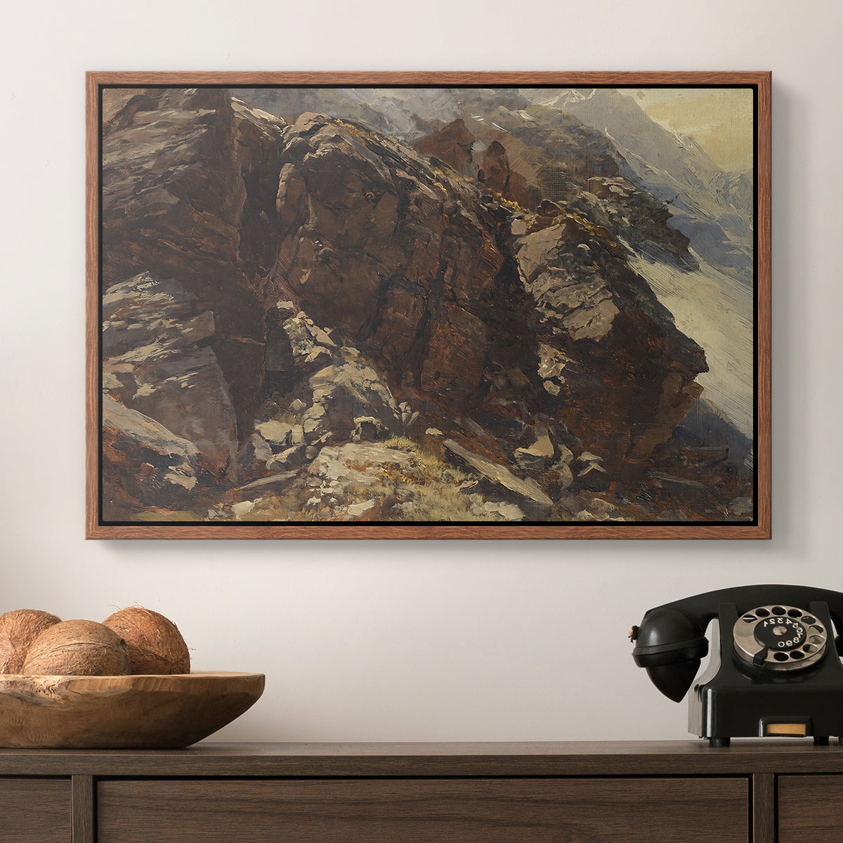 High Mountain Study, c. 1870 by Edward Theodore Compton in a walnut floater framed canvas displayed above a console table in a hallway, featuring a realistic depiction of mountainous terrain under open sky.