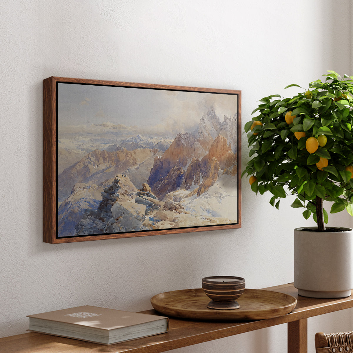 Col du Géant, 1903 by Edward Theodore Compton, presented in a walnut floater framed canvas featuring a mountain pass with snow-covered peaks and expansive alpine valley, displayed above a hallway console table.