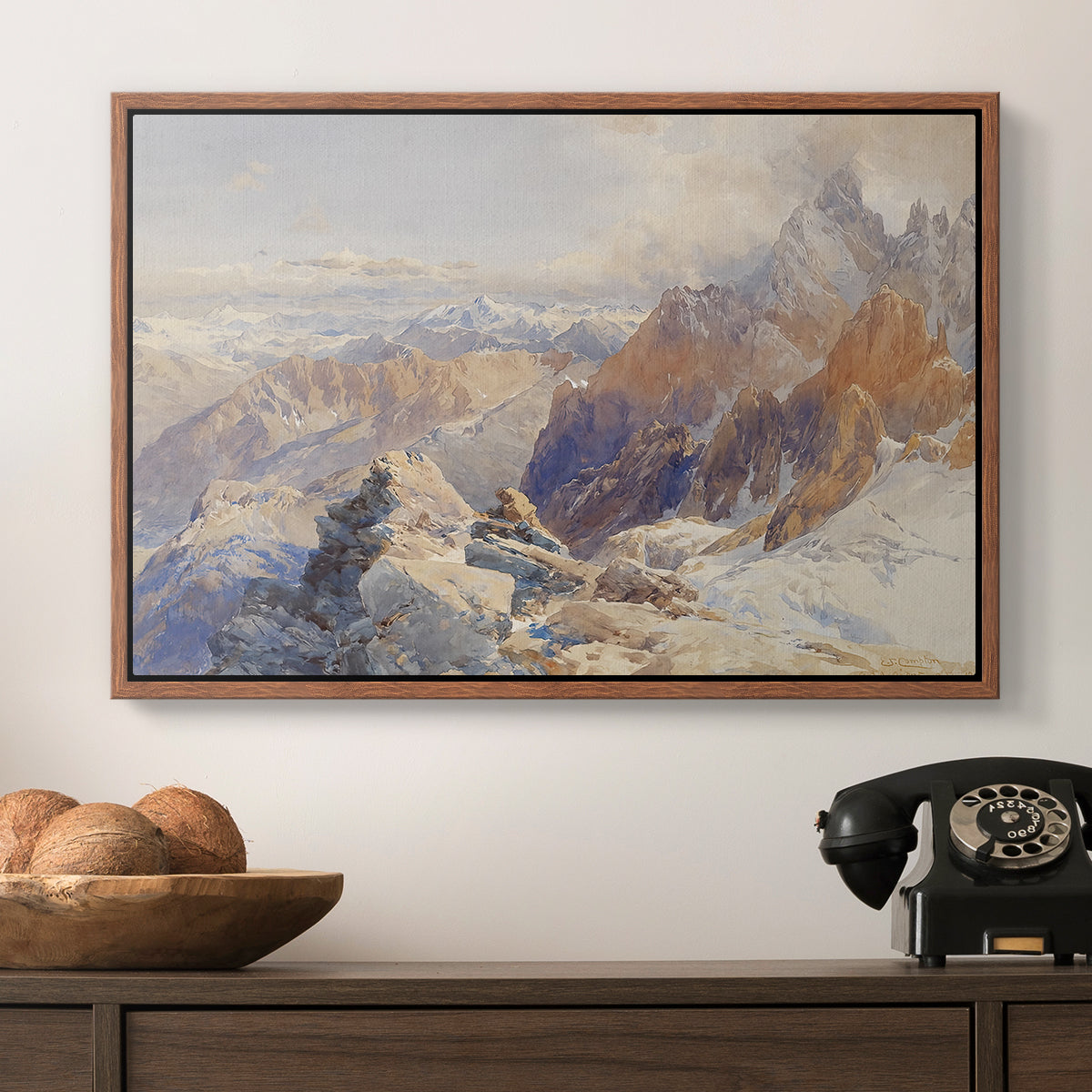 Col du Géant, 1903 by Edward Theodore Compton in a walnut floater framed canvas displayed above a console table in a hallway, featuring a rugged mountain pass scene with distant peaks.