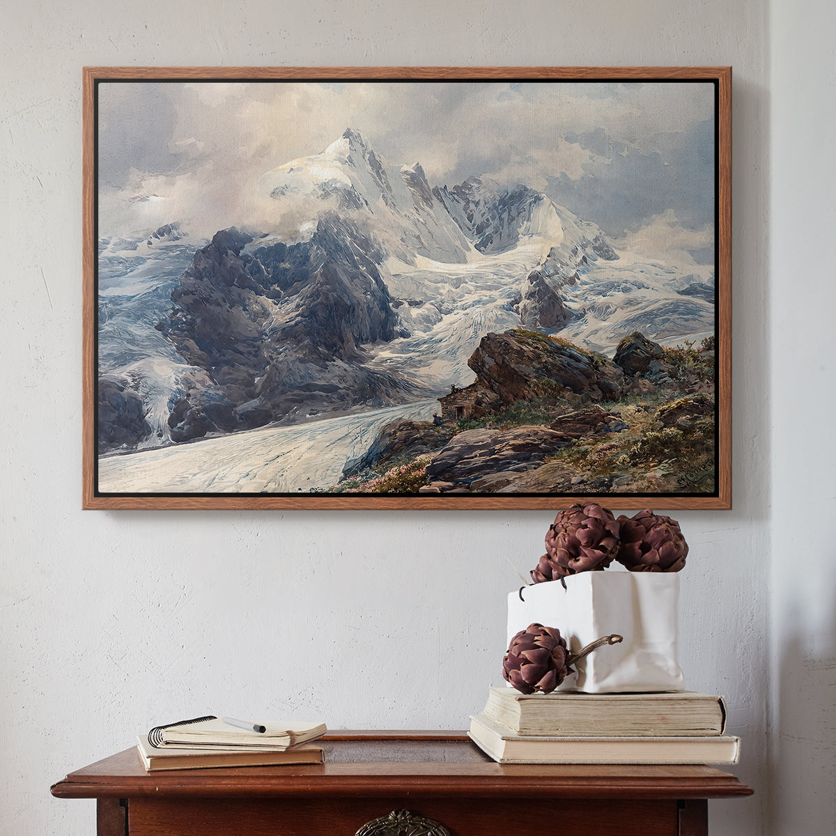 Walnut floater framed canvas featuring The Grossglockner, 1880 by Edward Theodore Compton above an entryway table in a minimalist foyer.