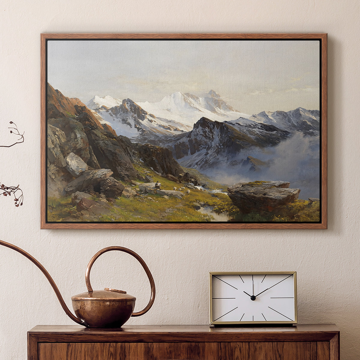 Walnut floater framed canvas featuring an alpine vista with towering peak and foreground terrain, displayed above a cabinet in a soft-toned living room.