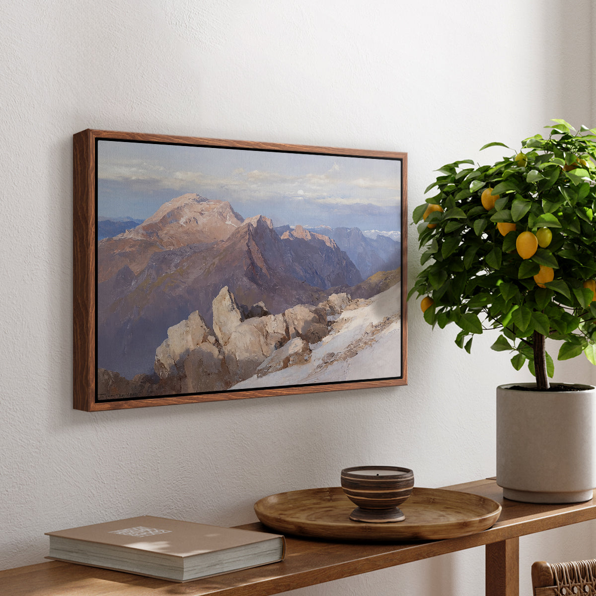 Hoher Göll from Watzmann-Hocheck, 1919 by Edward Theodore Compton, presented in a walnut floater framed canvas featuring a distant mountain peak viewed from elevated ridge with sweeping landscape, displayed above a hallway console table.