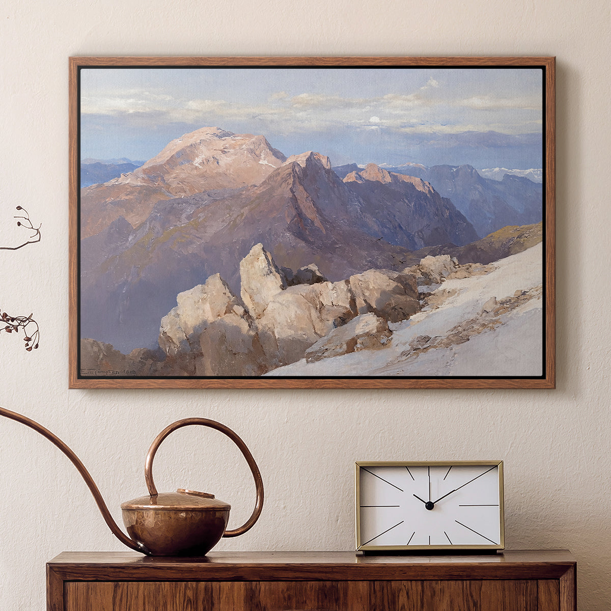 Walnut floater framed canvas featuring a high vantage point overlooking rugged mountain terrain, displayed above a cabinet in a soft-toned living room.