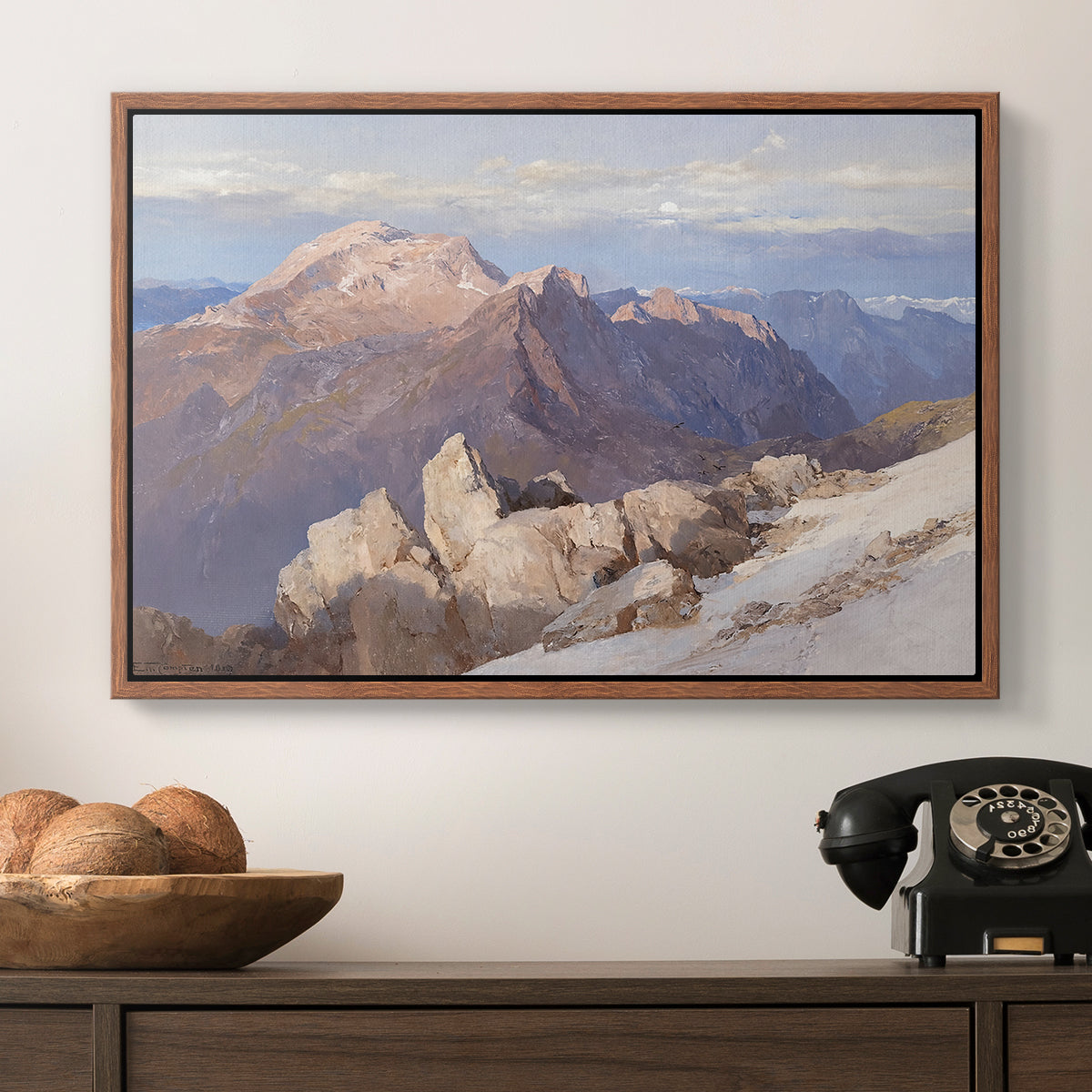 Hoher Göll from Watzmann-Hocheck, 1919 by Edward Theodore Compton in a walnut floater framed canvas displayed above a console table in a hallway, featuring an expansive mountainous landscape with natural depth.