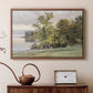 Walnut floater framed canvas featuring a natural setting with water, trees, and open sky, displayed above a cabinet in a soft-toned living room.