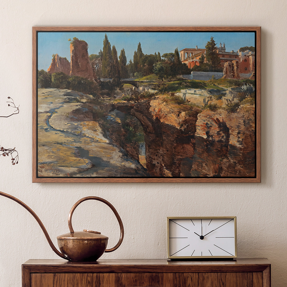 Walnut floater framed canvas featuring a cityscape with classical ruins and surrounding terrain, displayed above a cabinet in a soft-toned living room.