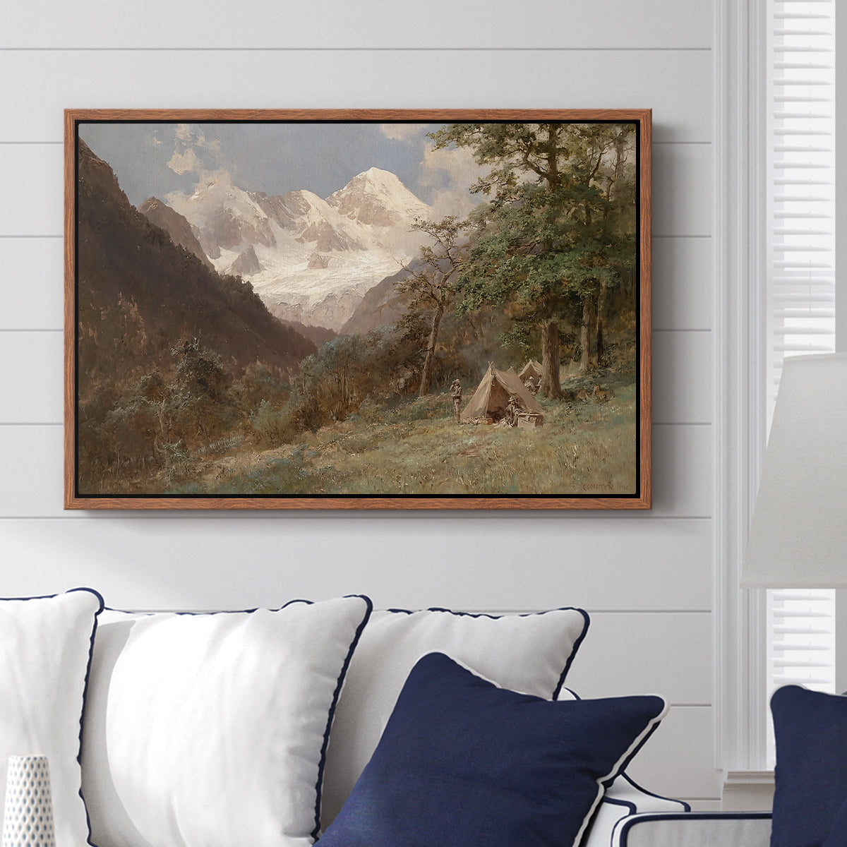 Landscape in the Caucasus, c. 1921 by Edward Theodore Compton displayed above a sofa in a living room in a walnut floater frame, featuring an expansive view of Caucasus mountains under open sky.